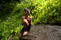 Young boy near a waterfall