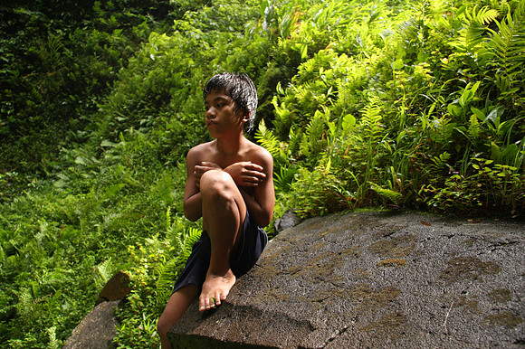 Young boy near a waterfall